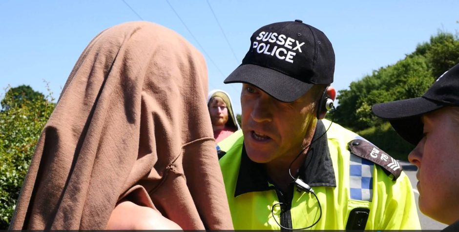 Sussex Police officer argues with protester
